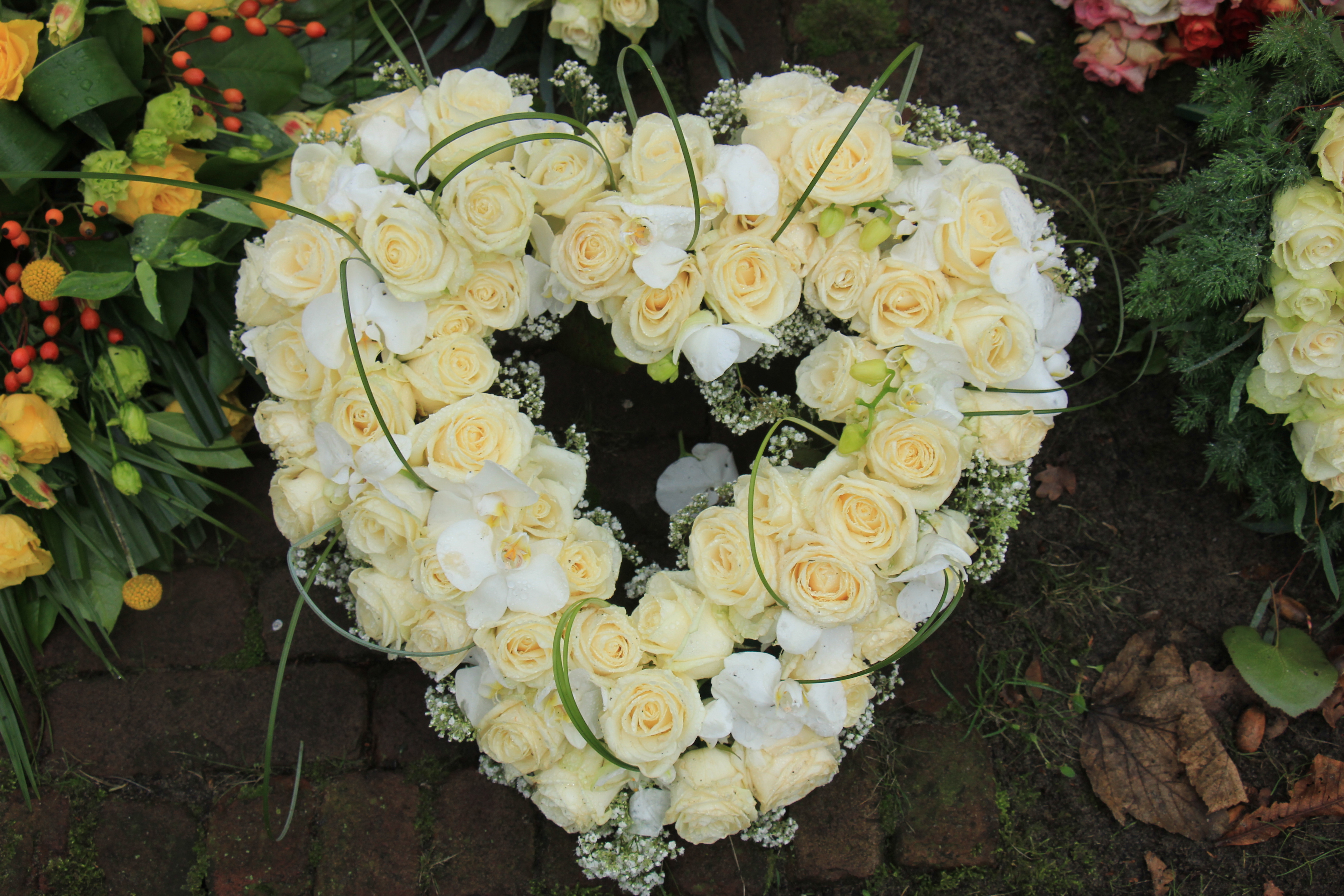 Coroa de flores amarela e branca em formato de coração